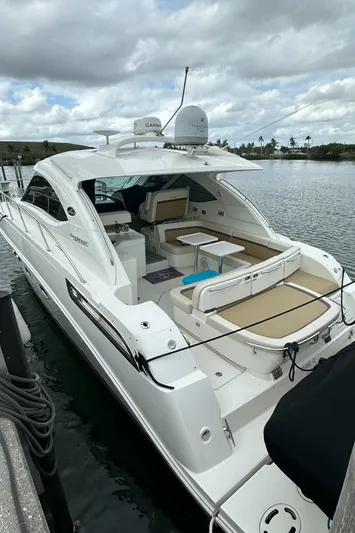  Yacht Photos Pics 2010 Sea Ray 470 Sundancer yacht docked on a calm waterway under cloudy skies.