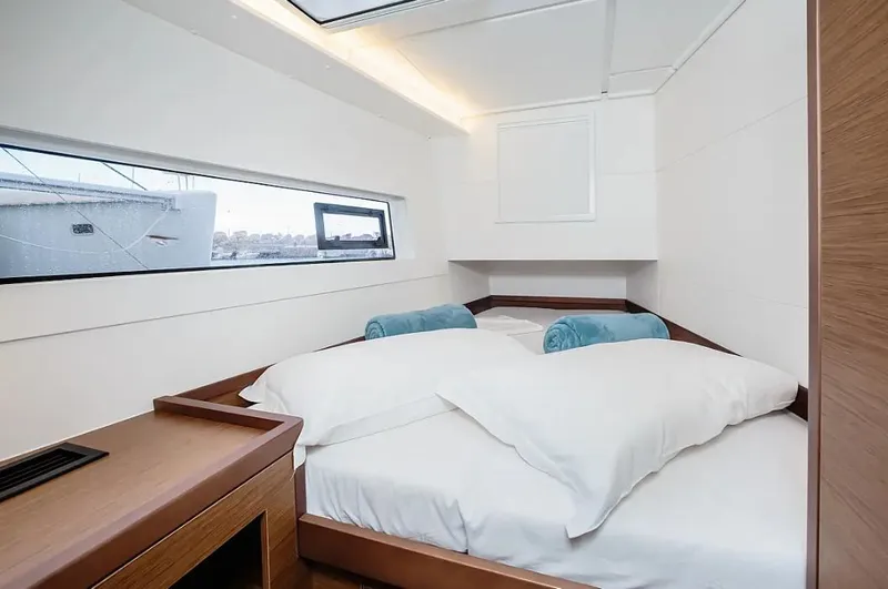  Yacht Photos Pics Luxurious cabin interior of 2019 Lagoon 40 catamaran with cozy bed and modern design.