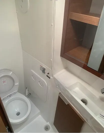  Yacht Photos Pics 2019 Lagoon 40 yacht bathroom with toilet, sink, and storage cabinet.
