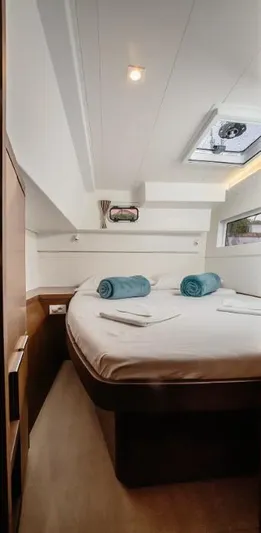  Yacht Photos Pics Interior cabin of 2019 Lagoon 40 catamaran with bed, skylight, and towels.