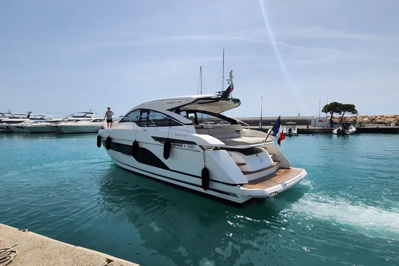  Yacht Photos Pics 2020 Fairline Targa 45 Open yacht cruising in a marina with clear blue water.