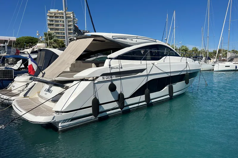  Yacht Photos Pics 2020 Fairline Targa 45 Open yacht docked in a marina under clear blue skies.