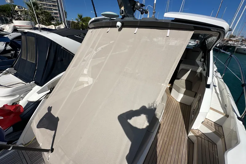  Yacht Photos Pics 2020 Fairline Targa 45 Open yacht with sunshade, docked in a marina.