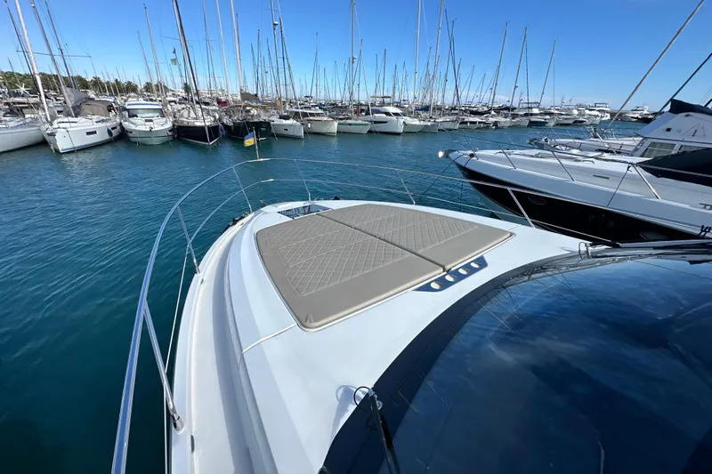  Yacht Photos Pics 2020 Fairline Targa 45 Open yacht docked in a marina with other boats.