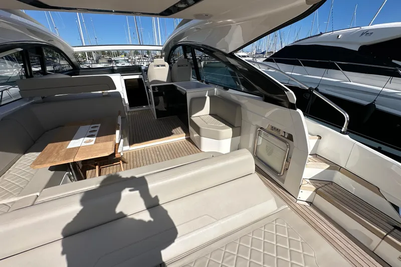  Yacht Photos Pics 2020 Fairline Targa 45 Open yacht interior with seating and table, docked at marina.