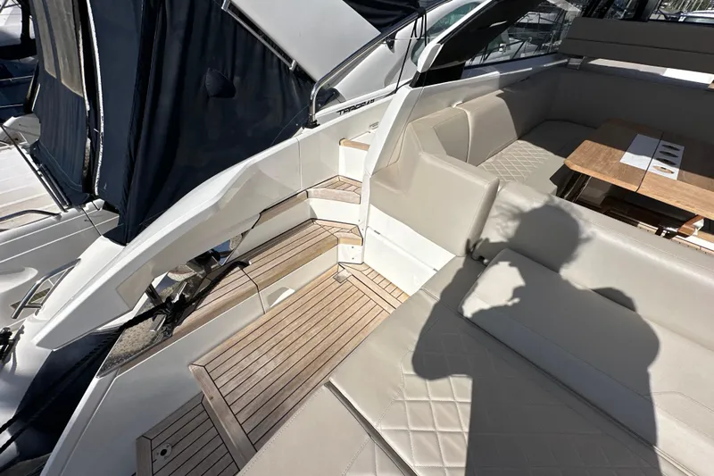  Yacht Photos Pics 2020 Fairline Targa 45 Open yacht interior with beige seating and wooden flooring.