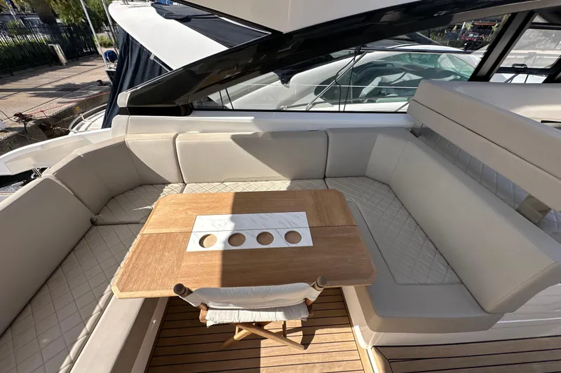  Yacht Photos Pics Luxurious seating area on 2020 Fairline Targa 45 Open yacht with wooden table.