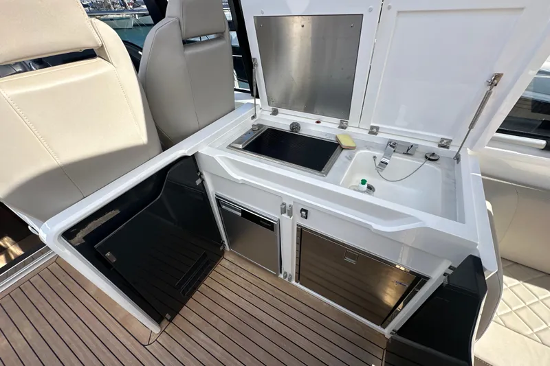  Yacht Photos Pics 2020 Fairline Targa 45 Open yacht kitchenette with sink, stove, and storage on teak deck.