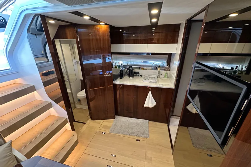  Yacht Photos Pics Luxurious interior of 2020 Fairline Targa 45 Open yacht with modern kitchen and elegant wood finishes.