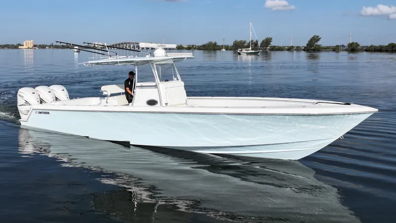  Yacht Photos Pics 2021 Contender 39 ST boat cruising on calm water with clear sky background.