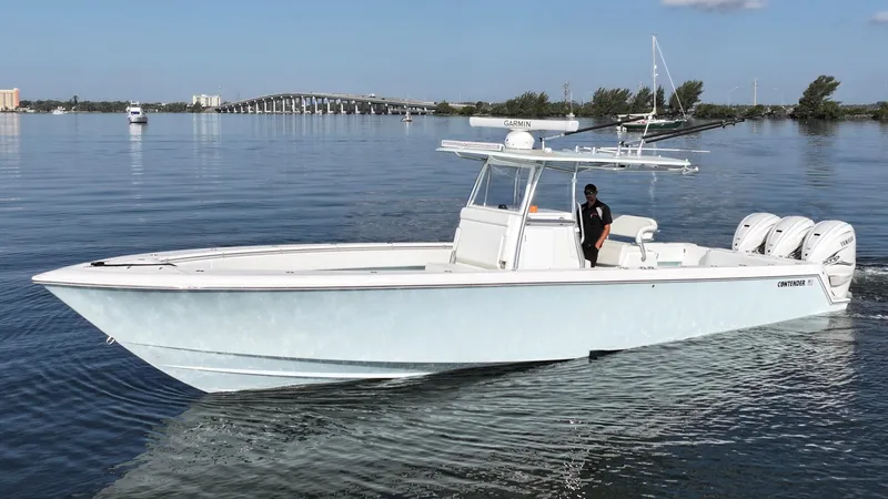  Yacht Photos Pics 2021 Contender 39 ST boat on calm water with bridge in background.