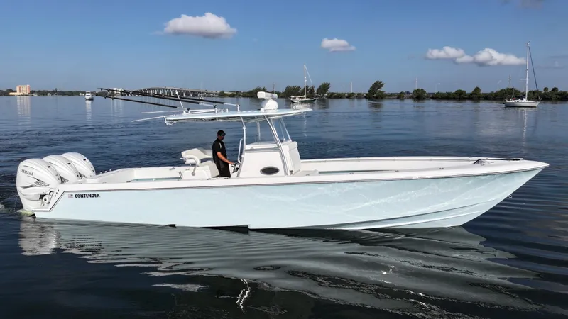  Yacht Photos Pics 2021 Contender 39 ST boat cruising on calm water under a clear blue sky.