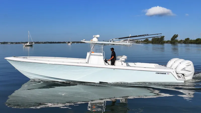  Yacht Photos Pics 2021 Contender 39 ST boat cruising on calm water under a clear blue sky.