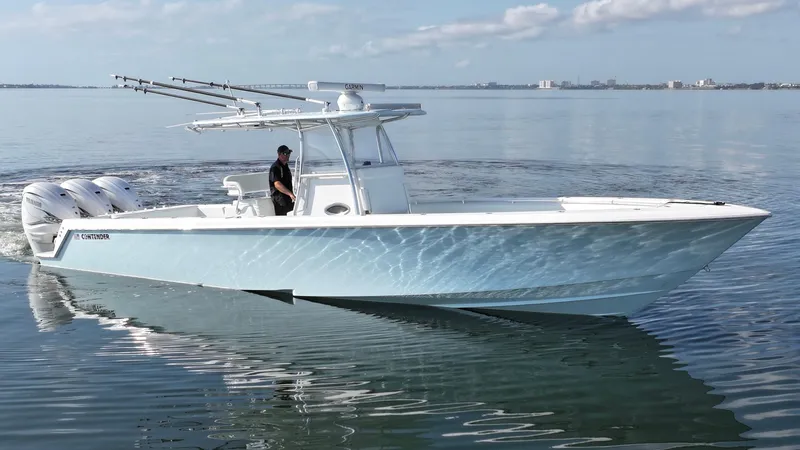  Yacht Photos Pics 2021 Contender 39 ST boat cruising on calm water with clear skies.