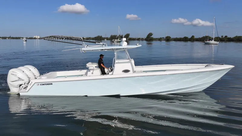  Yacht Photos Pics 2021 Contender 39 ST boat cruising on calm water under a clear blue sky.