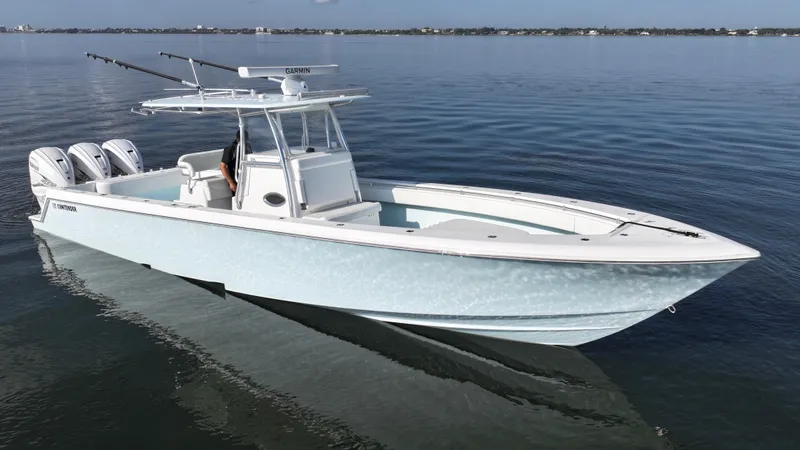  Yacht Photos Pics 2021 Contender 39 ST boat on calm water, featuring triple outboard engines.