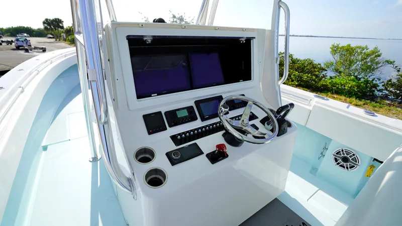  Yacht Photos Pics 2021 Contender 39 ST boat console with steering wheel and electronic controls.