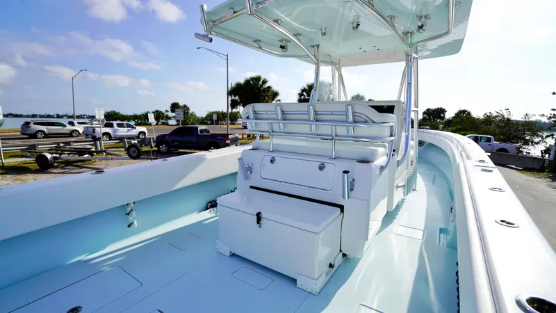  Yacht Photos Pics 2021 Contender 39 ST boat interior with seating and storage, docked near a waterfront.