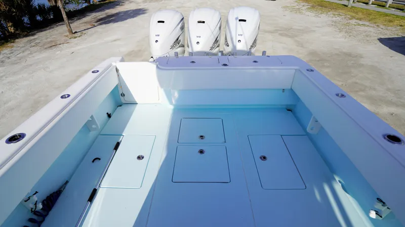 Yacht Photos Pics 2021 Contender 39 ST boat deck with triple outboard engines.