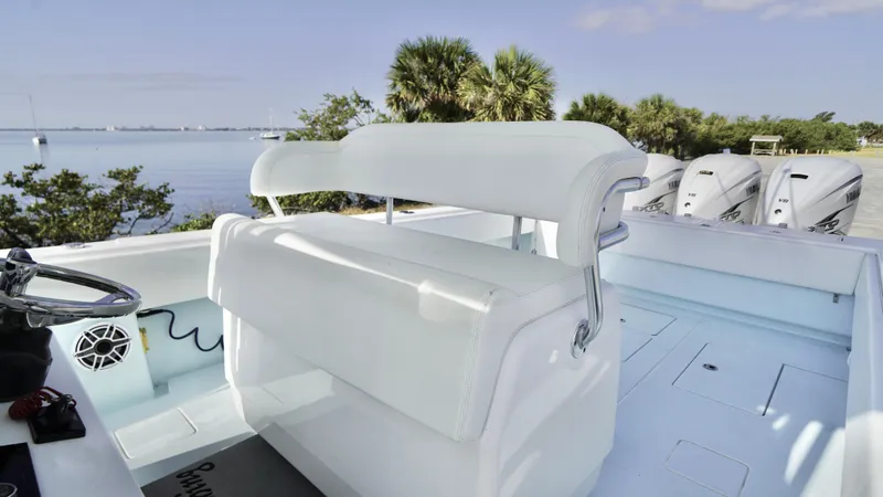  Yacht Photos Pics 2021 Contender 39 ST boat interior with white seating, ocean view, and triple outboard engines.