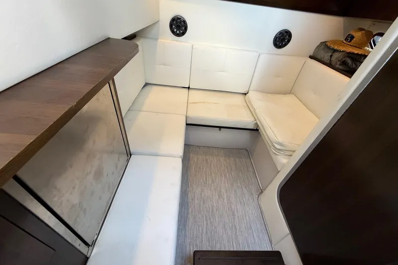  Yacht Photos Pics 2021 Cruisers Yachts 338 CX South Beach Bow Rider cabin interior with white seating and wood accents.