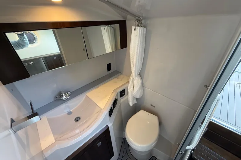  Yacht Photos Pics 2021 Cruisers Yachts 338 CX South Beach Bow Rider bathroom interior with sink and toilet.