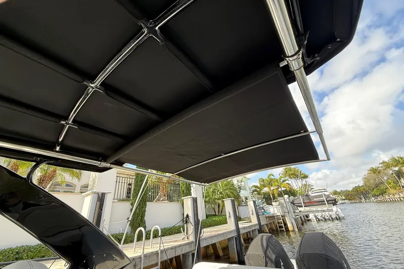  Yacht Photos Pics 2021 Cruisers Yachts 338 CX South Beach Bow Rider with black canopy, docked by waterfront.