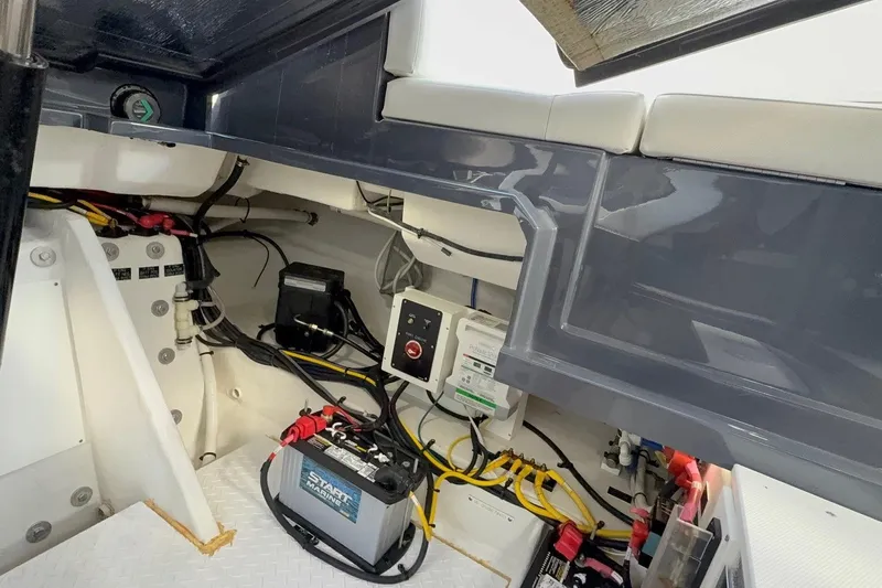  Yacht Photos Pics 2021 Cruisers Yachts 338 CX South Beach Bow Rider electrical compartment with battery and wiring.