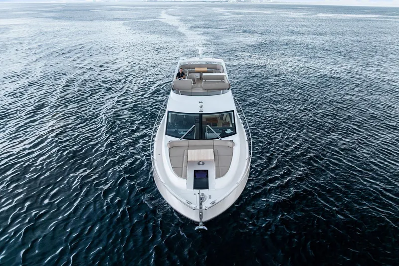 Miller Time Yacht Photos Pics 2021 Sunseeker Manhattan 52 yacht cruising on open water, aerial view.