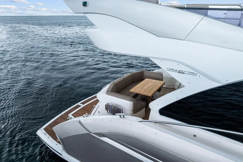 Miller Time Yacht Photos Pics 2021 Sunseeker Manhattan 52 yacht on open water, featuring elegant deck seating.