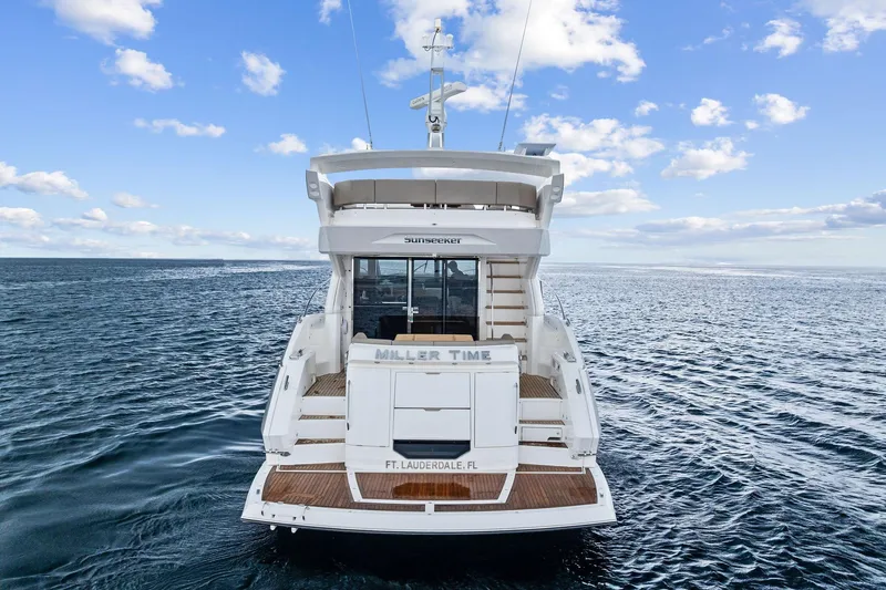 Miller Time Yacht Photos Pics 2021 Sunseeker Manhattan 52 yacht on open sea, rear view, clear sky.