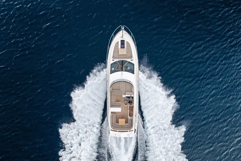 Miller Time Yacht Photos Pics Aerial view of 2021 Sunseeker Manhattan 52 yacht cruising on open water.
