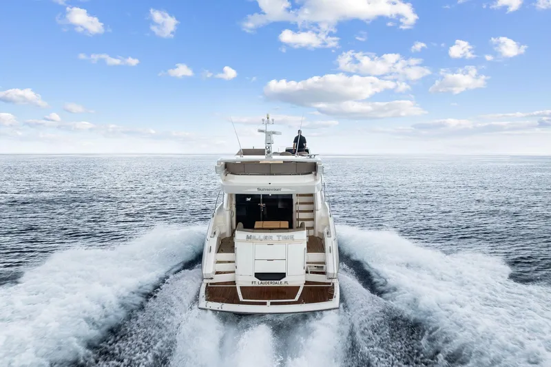 Miller Time Yacht Photos Pics 2021 Sunseeker Manhattan 52 yacht cruising on open sea under blue sky.