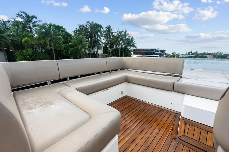 Miller Time Yacht Photos Pics Luxurious seating area on 2021 Sunseeker Manhattan 52 yacht, with scenic waterfront view.