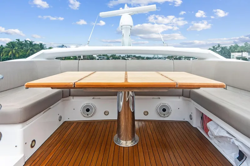 Miller Time Yacht Photos Pics Luxurious Sunseeker Manhattan 52 yacht deck with wooden table, 2021 model.
