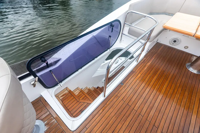 Miller Time Yacht Photos Pics 2021 Sunseeker Manhattan 52 yacht with teak deck and open hatch to lower deck.