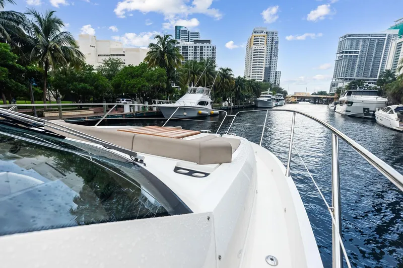 Miller Time Yacht Photos Pics Sunseeker Manhattan 52 yacht cruising through a scenic urban waterway, 2021 model.