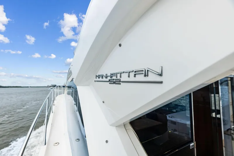 Miller Time Yacht Photos Pics 2021 Sunseeker Manhattan 52 yacht cruising on open water under a clear blue sky.