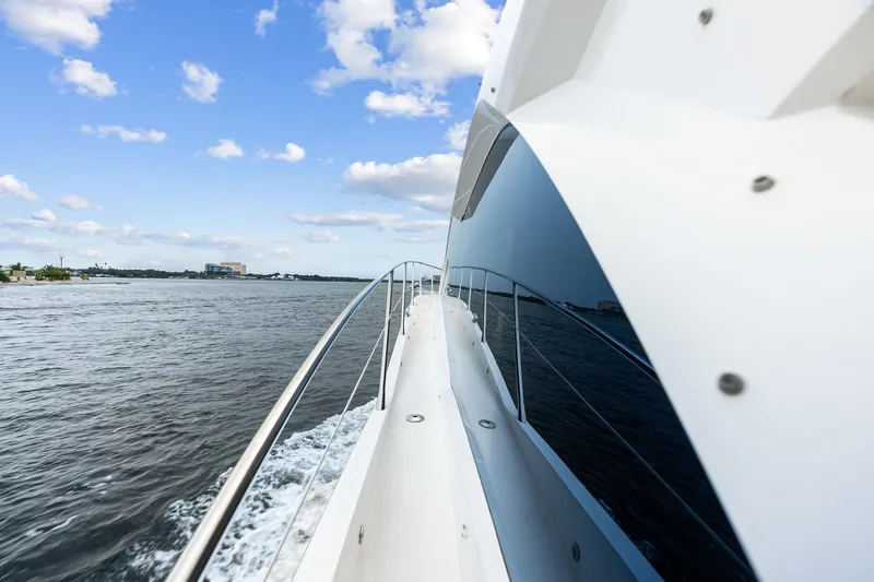 Miller Time Yacht Photos Pics 2020 Sunseeker Manhattan 52 yacht cruising on open water under a blue sky.