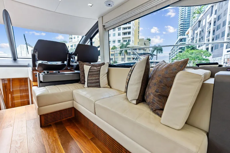 Miller Time Yacht Photos Pics Luxurious interior of 2021 Sunseeker Manhattan 52 yacht with plush seating and city view.