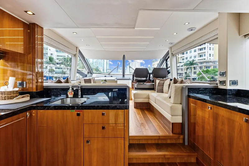 Miller Time Yacht Photos Pics Luxurious interior of 2021 Sunseeker Manhattan 52 yacht with modern kitchen and seating area.