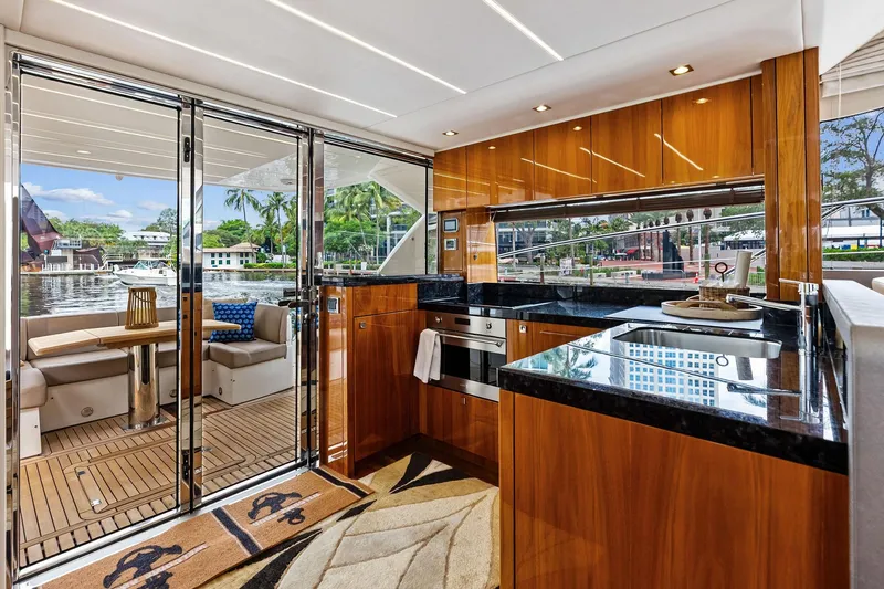 Miller Time Yacht Photos Pics Luxurious interior of 2021 Sunseeker Manhattan 52 yacht with modern kitchen and outdoor seating.