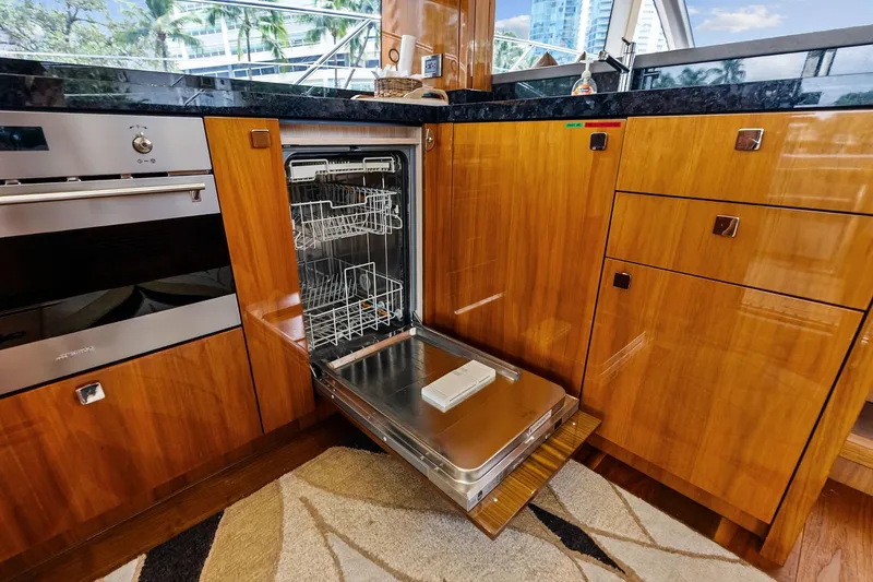 Miller Time Yacht Photos Pics Luxurious kitchen interior of 2021 Sunseeker Manhattan 52 yacht with open dishwasher.