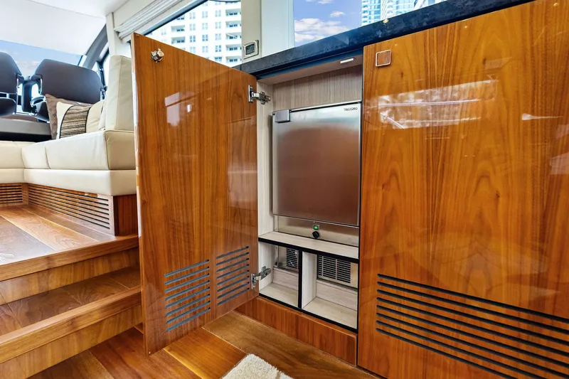 Miller Time Yacht Photos Pics Luxurious interior of 2021 Sunseeker Manhattan 52 yacht with wooden cabinetry and seating.