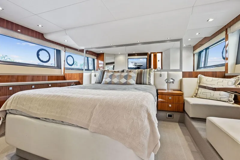Miller Time Yacht Photos Pics Luxurious bedroom interior of 2021 Sunseeker Manhattan 52 yacht, featuring elegant design and ample natural light.