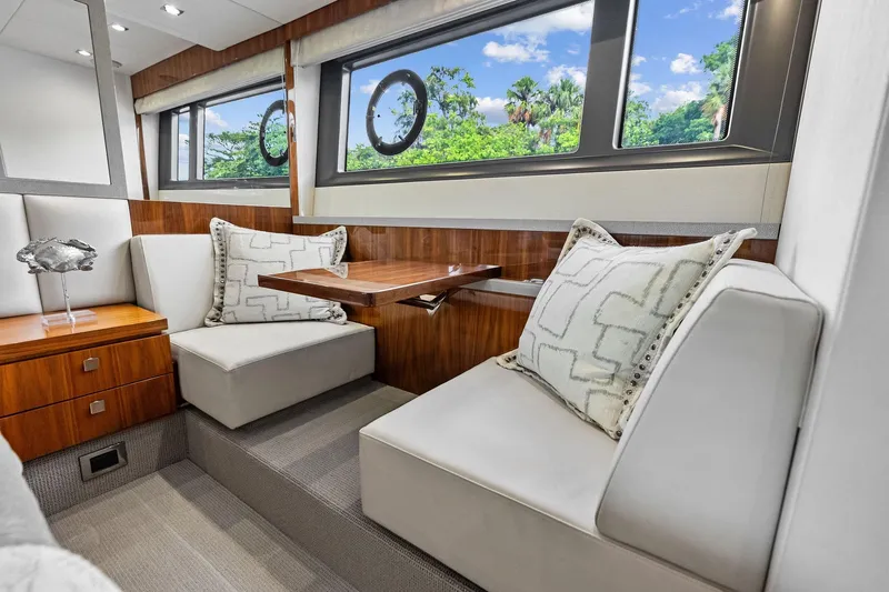 Miller Time Yacht Photos Pics Luxurious interior of 2021 Sunseeker Manhattan 52 yacht with elegant seating and scenic windows.