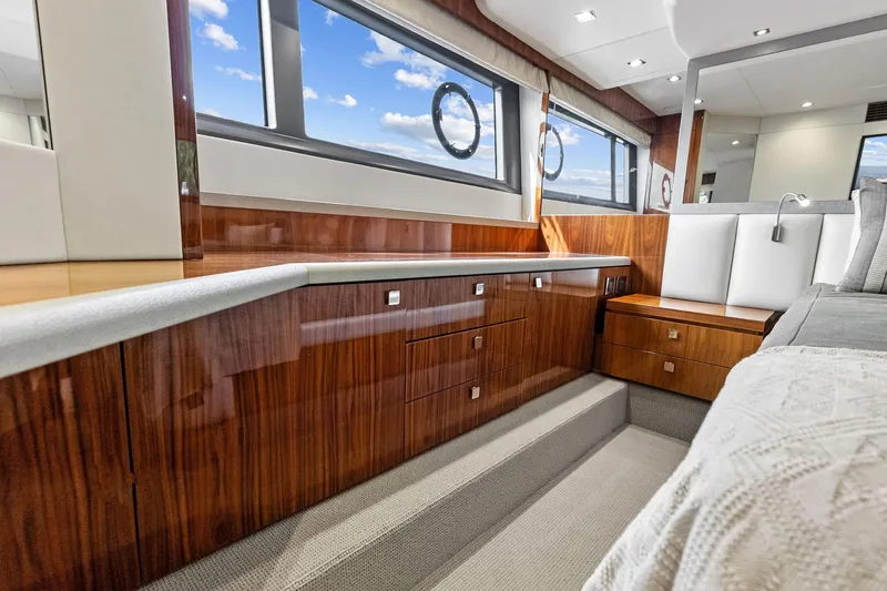 Miller Time Yacht Photos Pics Luxurious interior of 2021 Sunseeker Manhattan 52 yacht with elegant wood cabinetry.