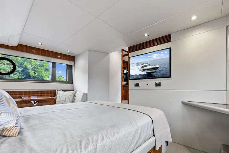 Miller Time Yacht Photos Pics Luxurious interior of 2021 Sunseeker Manhattan 52 yacht, featuring elegant bedroom and modern amenities.