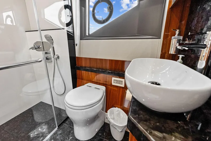 Miller Time Yacht Photos Pics Luxurious bathroom in 2021 Sunseeker Manhattan 52 yacht, featuring modern fixtures and elegant design.