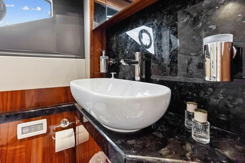 Miller Time Yacht Photos Pics Luxurious bathroom interior of 2021 Sunseeker Manhattan 52 yacht with modern sink and fixtures.